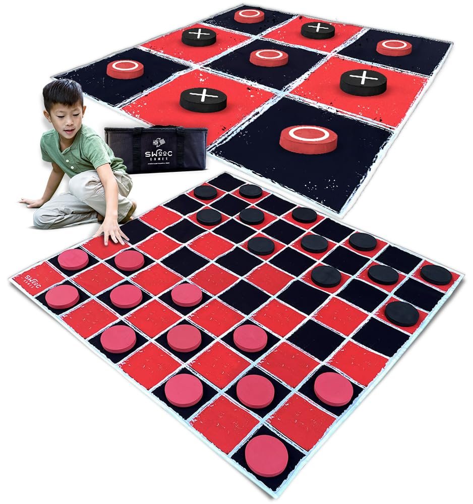 Boy playing giant checkers game with red and black pieces