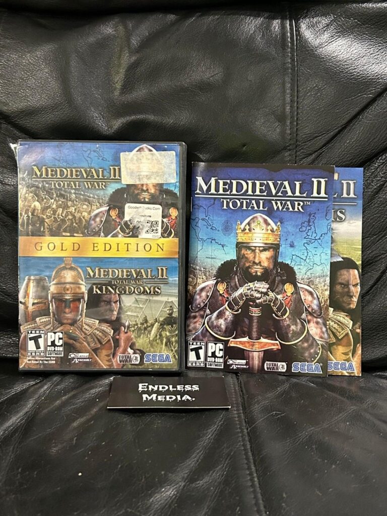 Two Medieval II: Total War PC game boxes on a leather surface